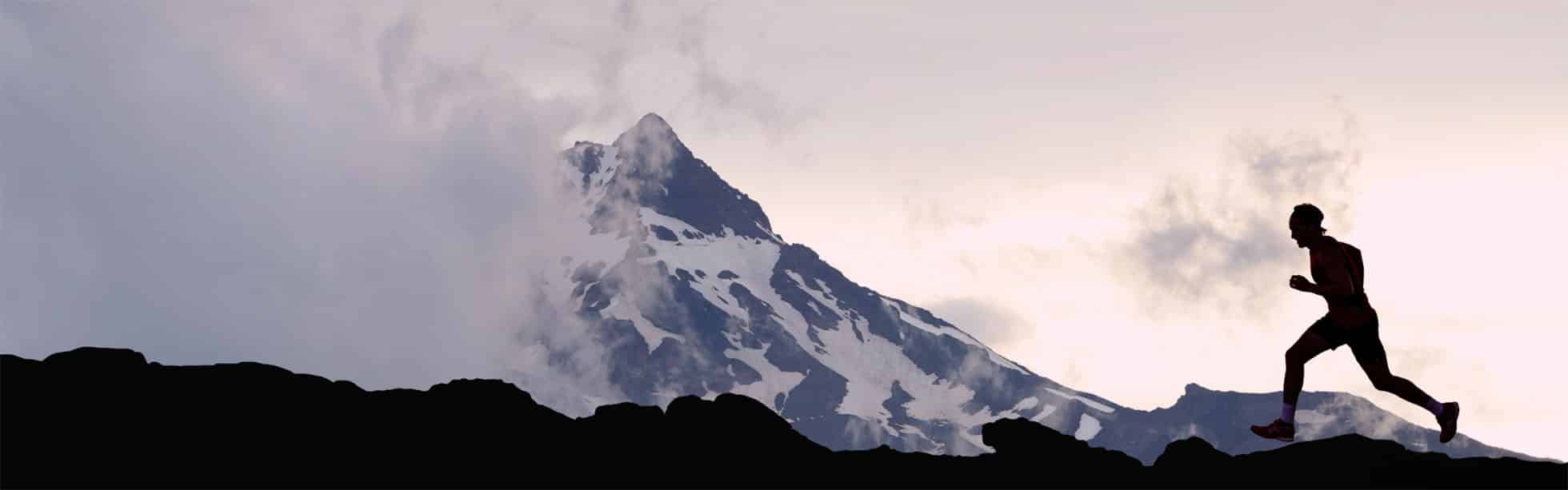 Person running through mountainous terrain