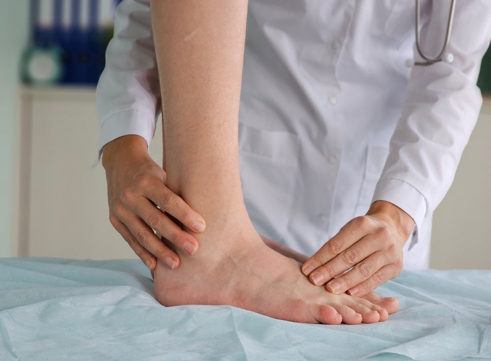 Person with flat feet receiving a consult from a podiatrist.