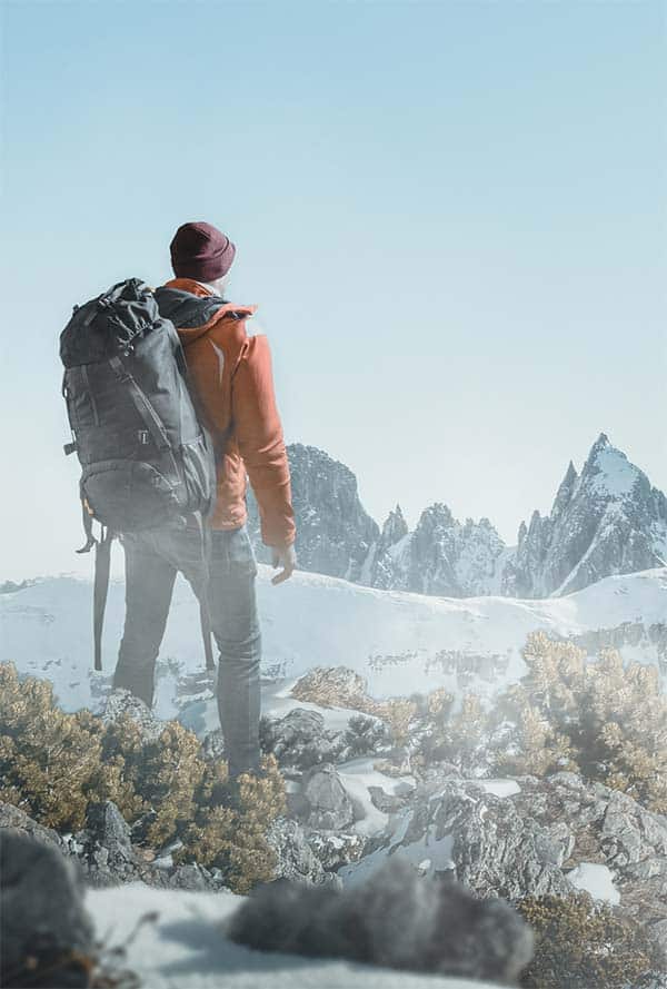 Hiker with backpack in snowy landscape