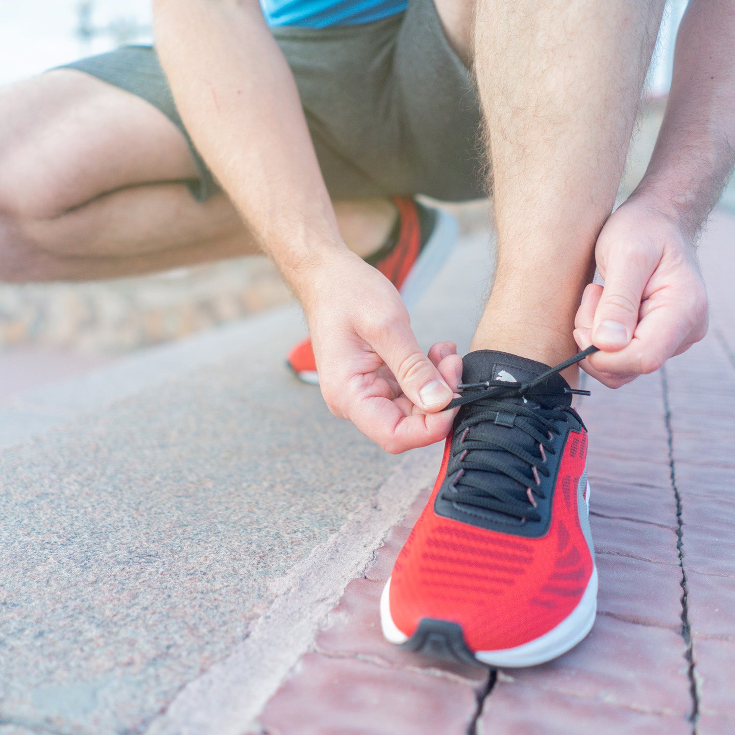 Man lacing up sports shoe