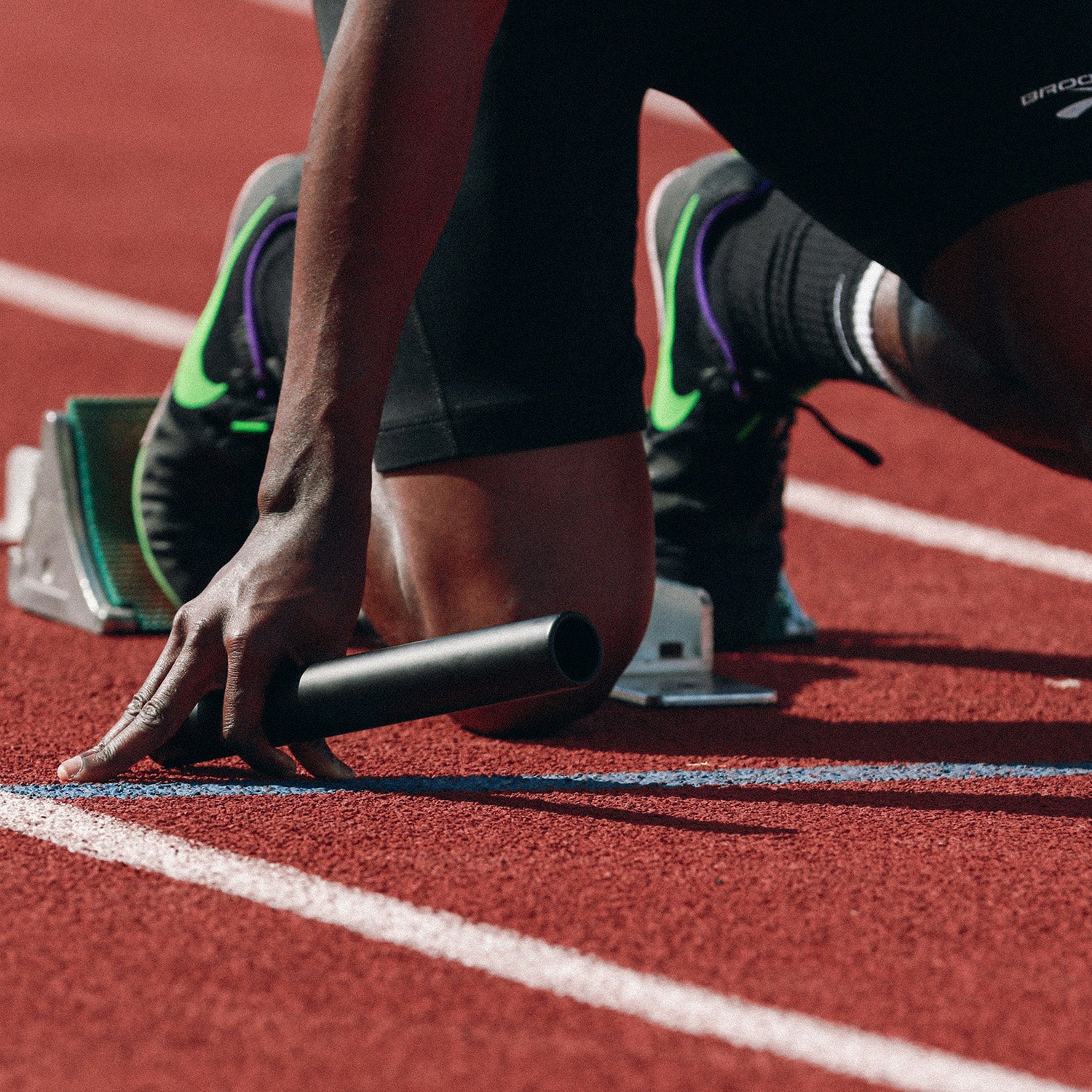 Runner holding batton