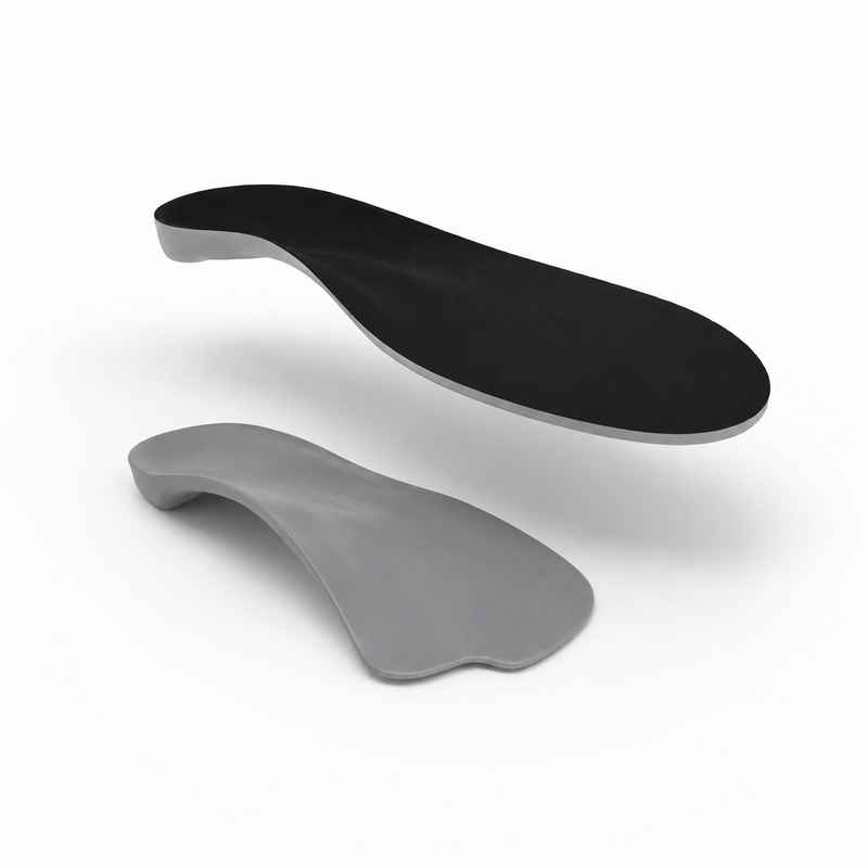 Black and gray shoe insoles on a white background