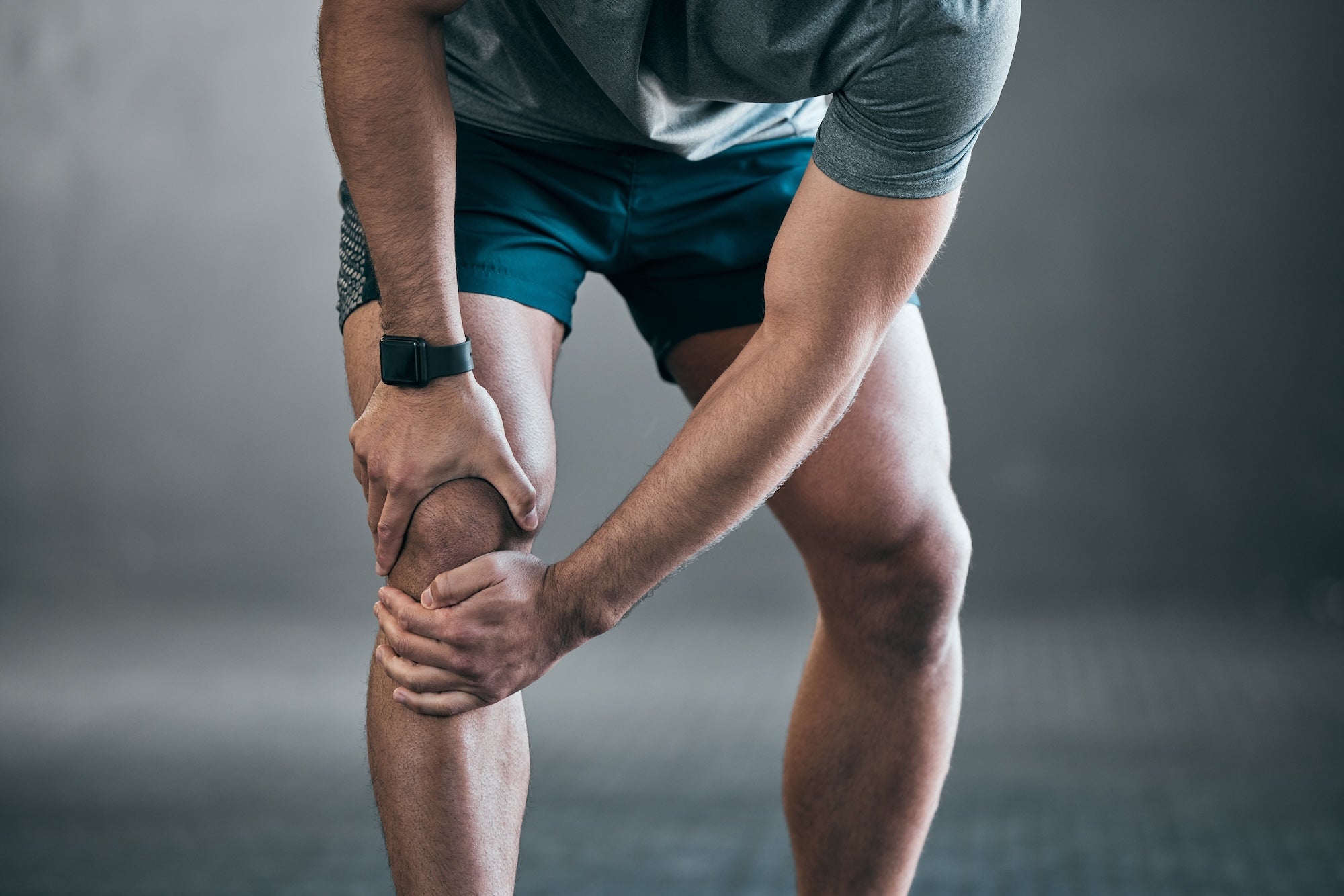 man holding his knee in pain